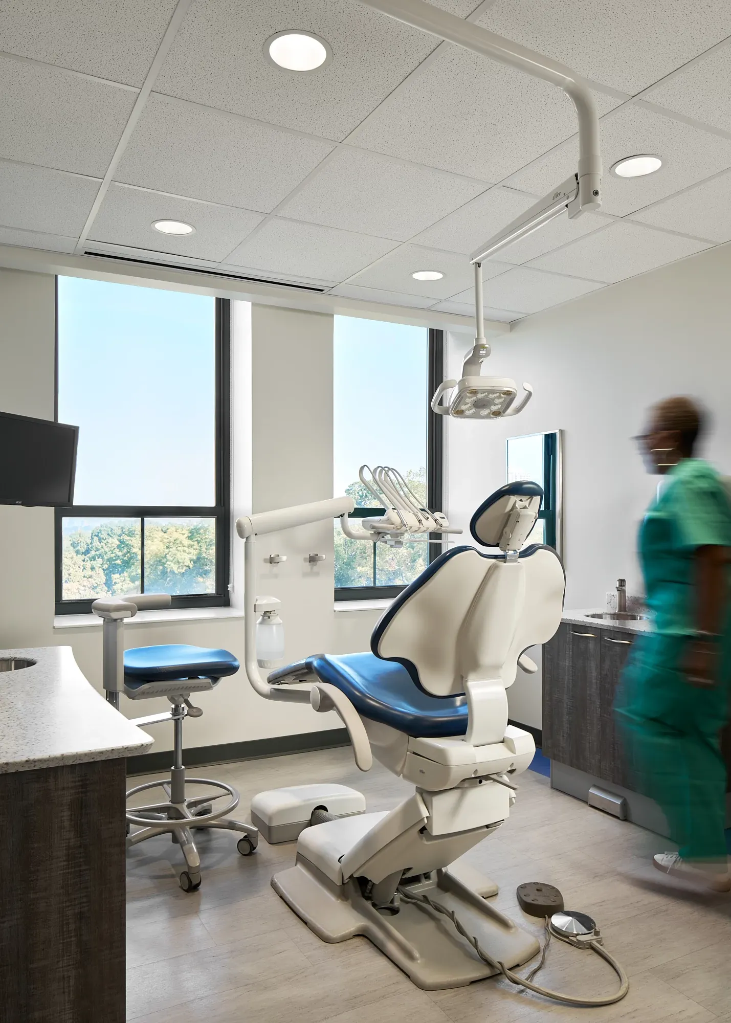 Modern dental office with sleek dental chair and commercial flooring