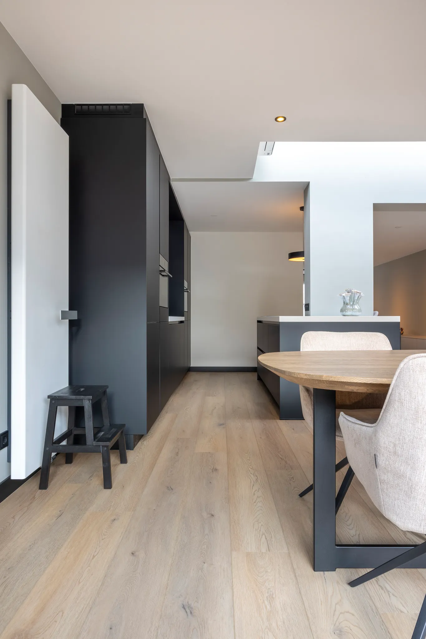 Light oak hardwood flooring in a modern kitchen and dining area