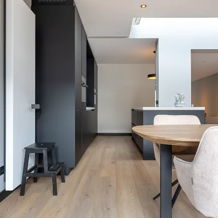 Light oak hardwood flooring in a modern kitchen and dining area