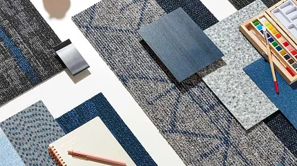 Blue and Gray Commercial Carpet Tile Swatches with Art Supplies Assorted blue and gray commercial carpet tile swatches with art supplies on a white background