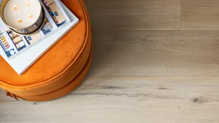Coretec Residential WPC LVP Flooring - 72.05x8.85 inch Wood Look Vinyl Planks Light wood look luxury vinyl plank flooring with orange ottoman and magazines