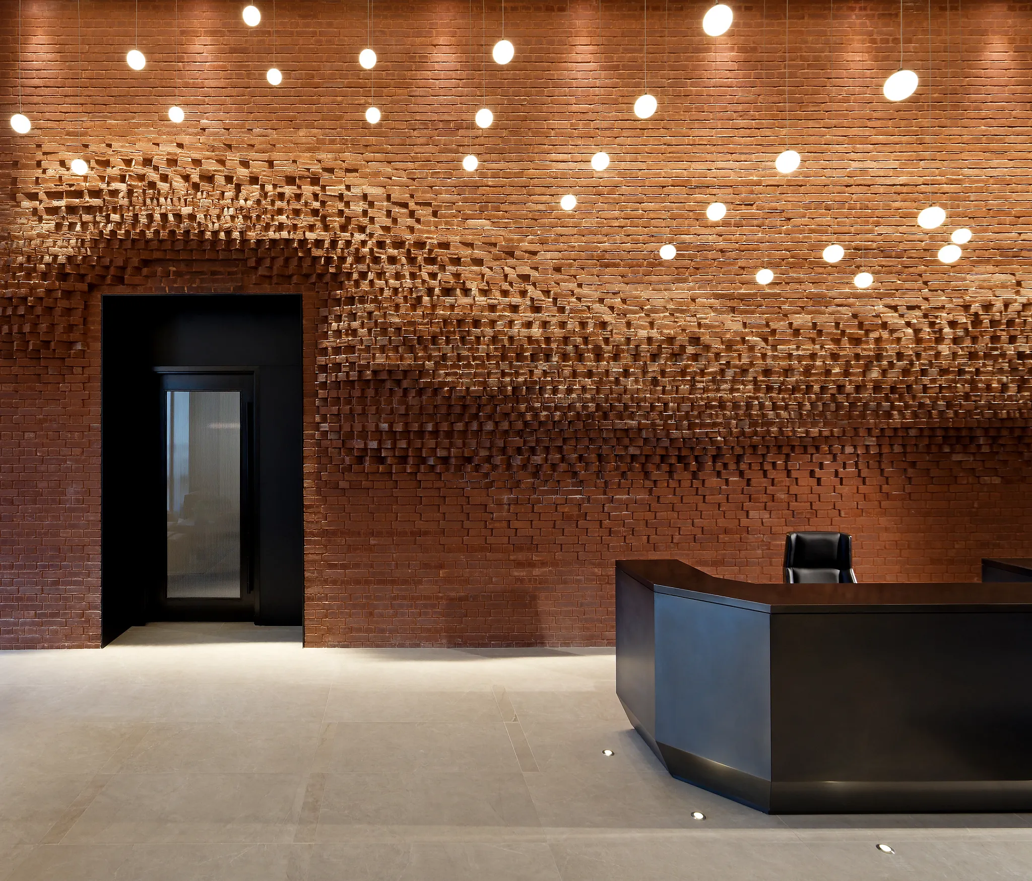 Modern reception area with brick wall and commercial flooring