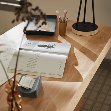 Light Hardwood Flooring in Modern Office Setting Modern office desk with open book and lamp on light hardwood flooring