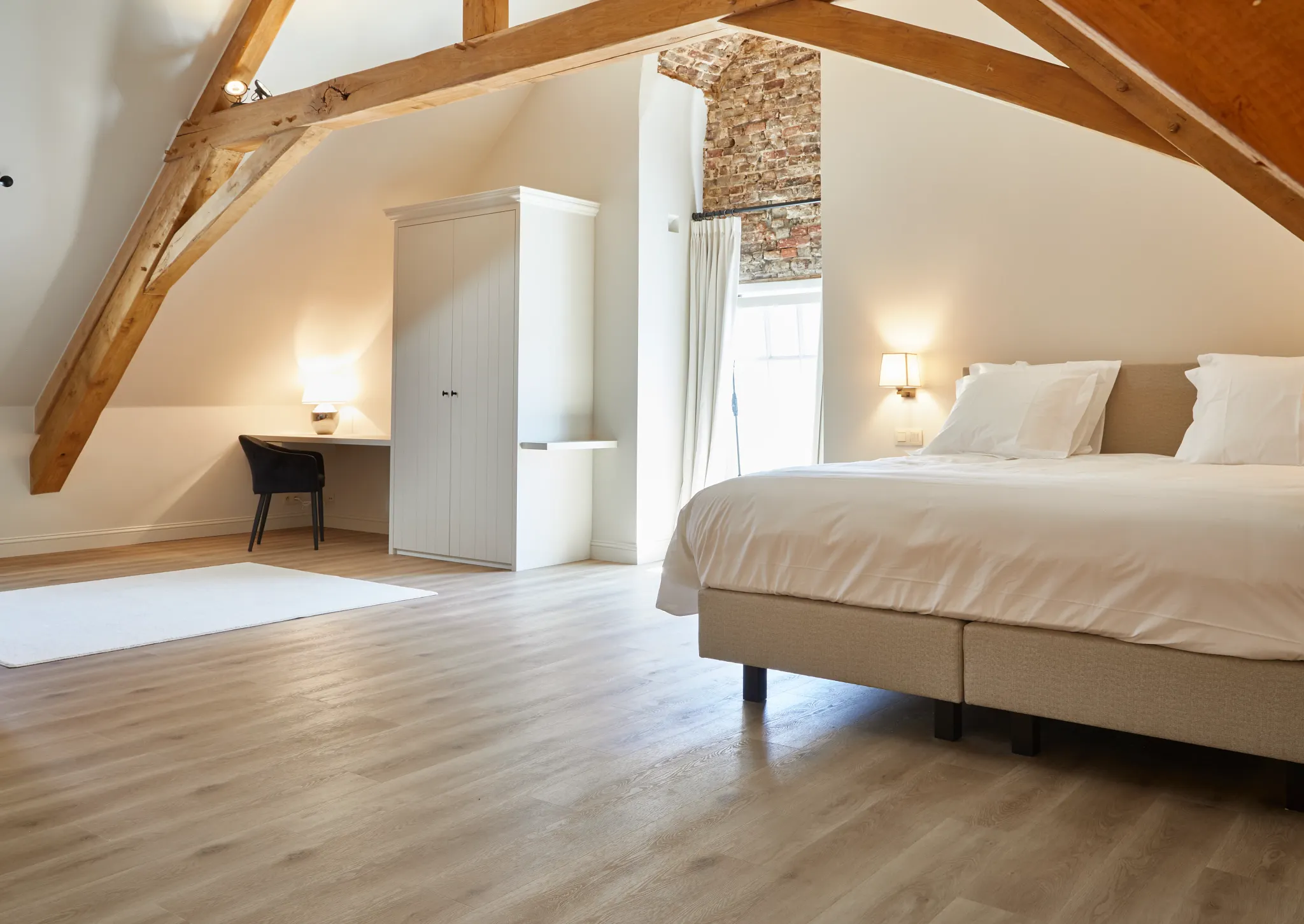 Hotel room bedroom with study and wooden Coretec floor