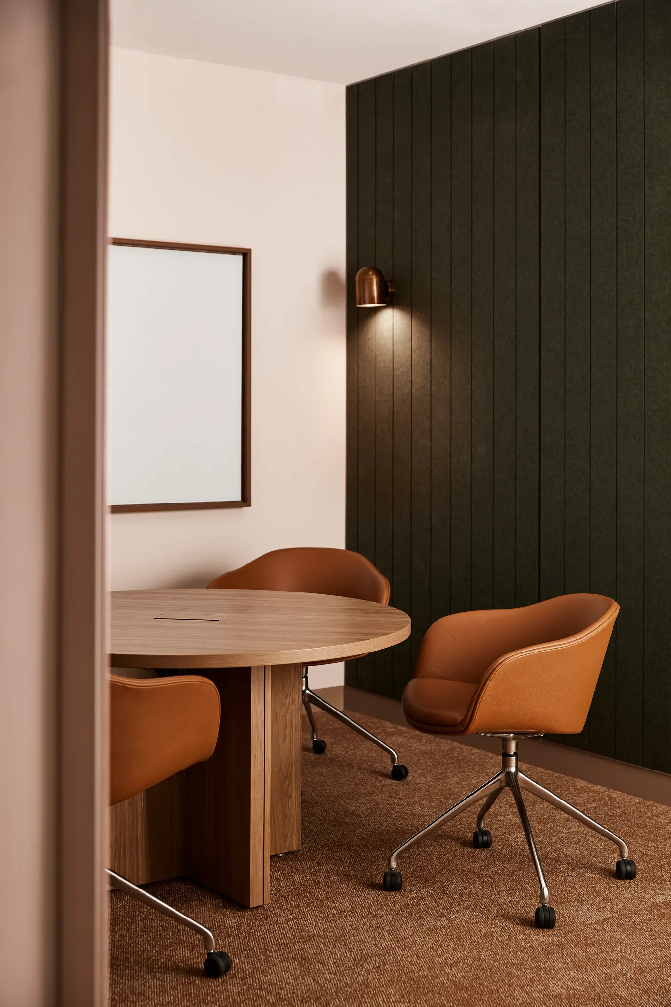 Modern office space with brown carpet flooring and leather chairs