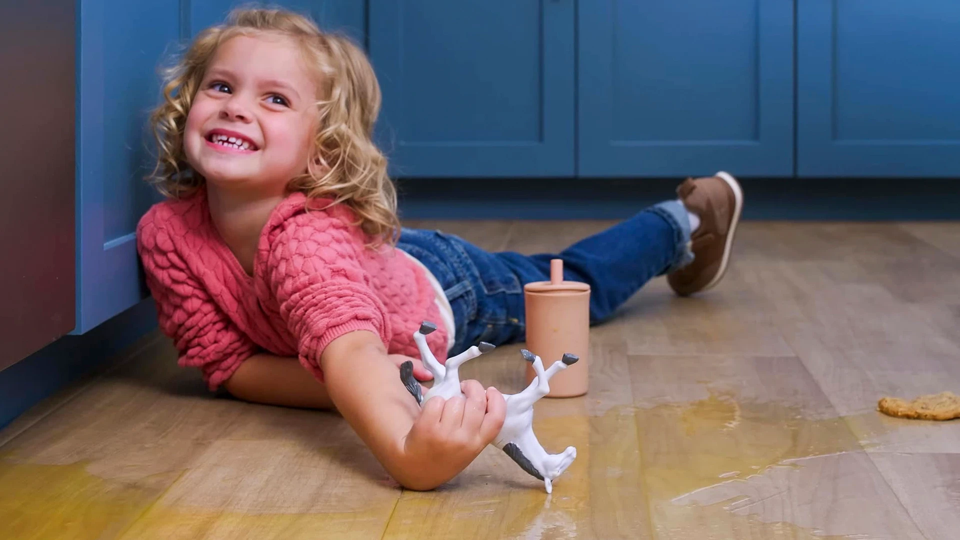 Child playing on waterproof luxury vinyl plank flooring in a kitchen setting
