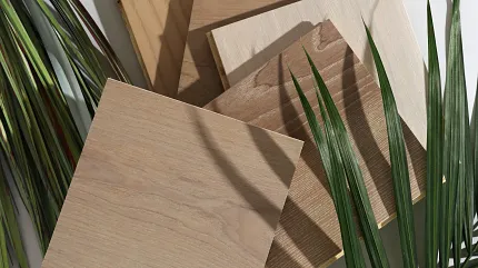 Light Brown and Beige Hardwood Flooring Swatches with Green Leaves Hardwood flooring swatches in light brown, beige, and natural wood tones with green leaves