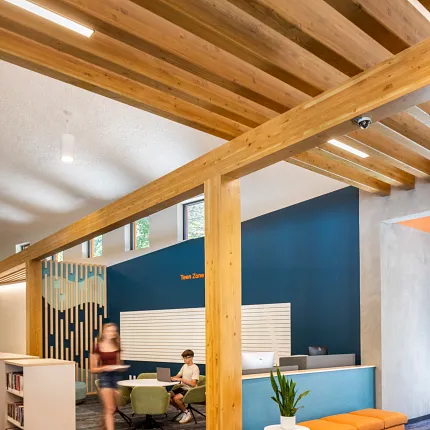 Education Facility with Commercial Carpet Tile Flooring and Wooden Beams Modern education facility with exposed wooden beams and commercial carpet tile flooring in shades of blue and gray