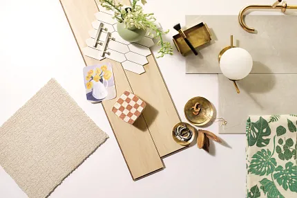 Versatile Flooring Options for a Comfortable Home - Laminate, Carpet, Tile, and Stone Samples. A flat lay of various flooring samples including light wood laminate planks, beige carpet swatch, white hexagonal tiles, and gray stone tile