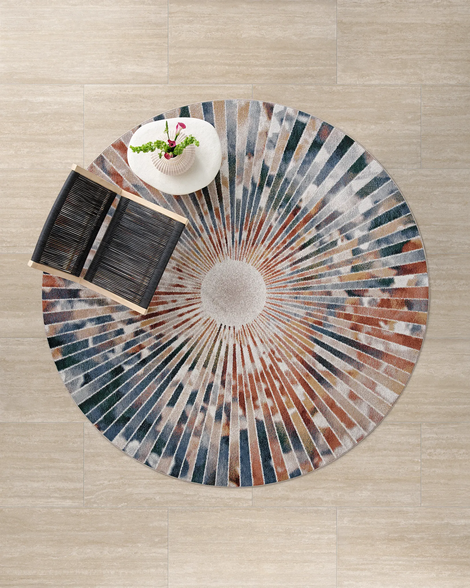 Round multicolor rug on beige tile flooring with chair and plant