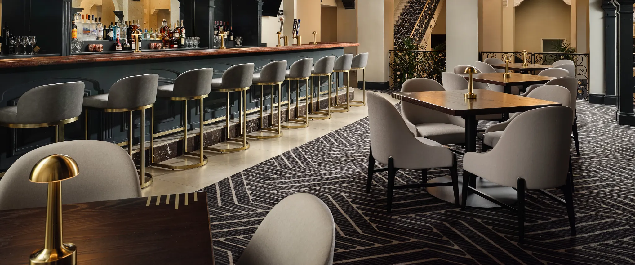Stylish hospitality bar with patterned carpet flooring