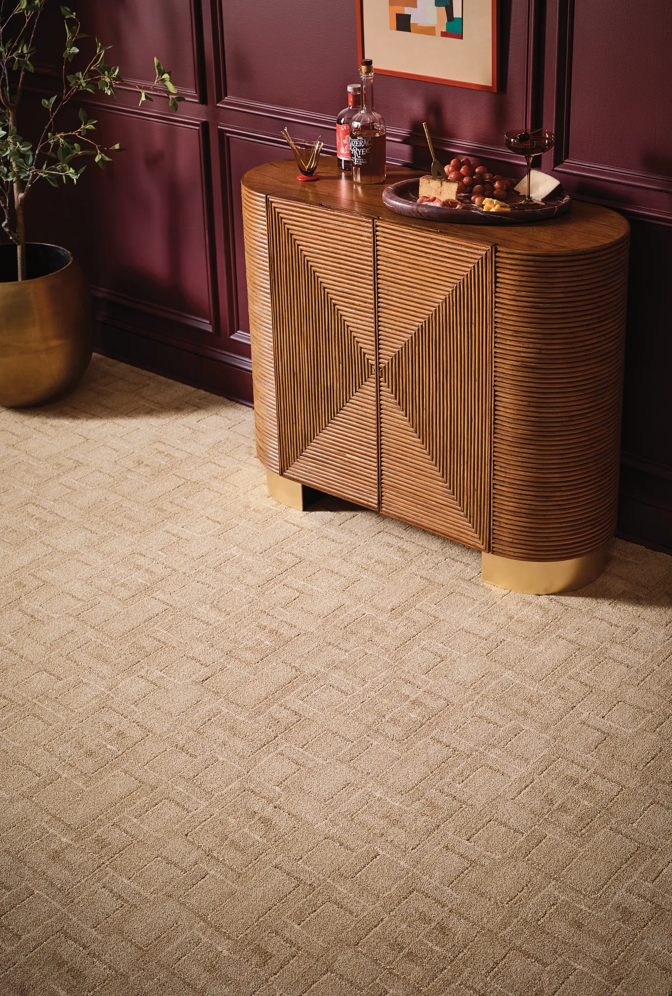Elegant beige broadloom carpet in a sophisticated room setting with a wooden cabinet and decorative items