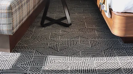 Stylish hospitality carpet for contemporary hotel interiors Modern hotel room with geometric patterned carpet flooring