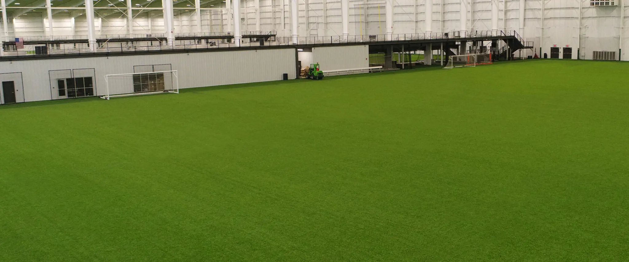 Indoor sports facility with green artificial turf