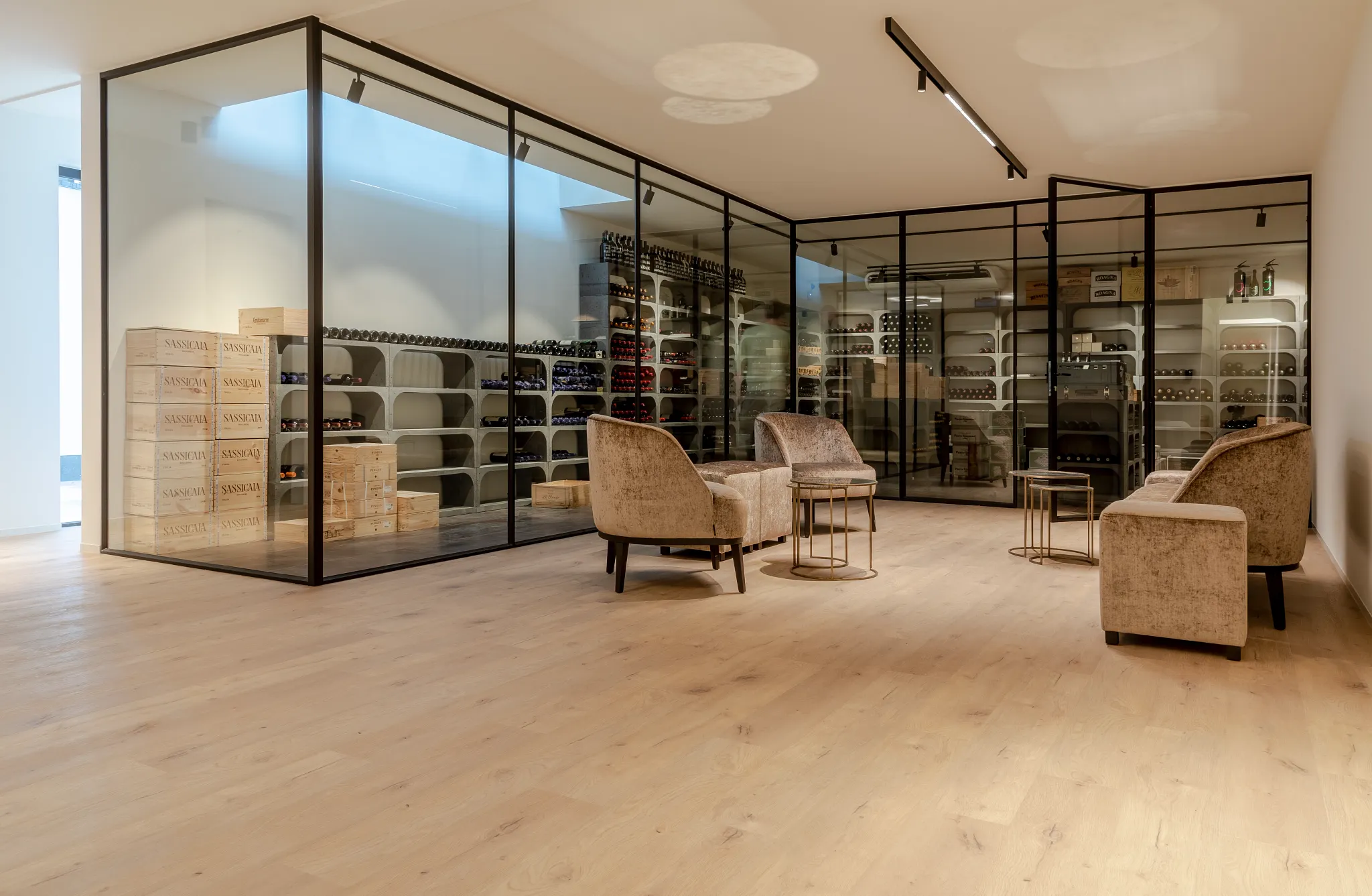 Modern wine cellar with light wood flooring and comfortable seating