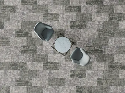 Modern Office Space with Gray and Green Commercial Carpet Tile Flooring Overhead view of a modern office space with two gray chairs and a small marble-top table on a patterned gray and green commercial carpet tile floor