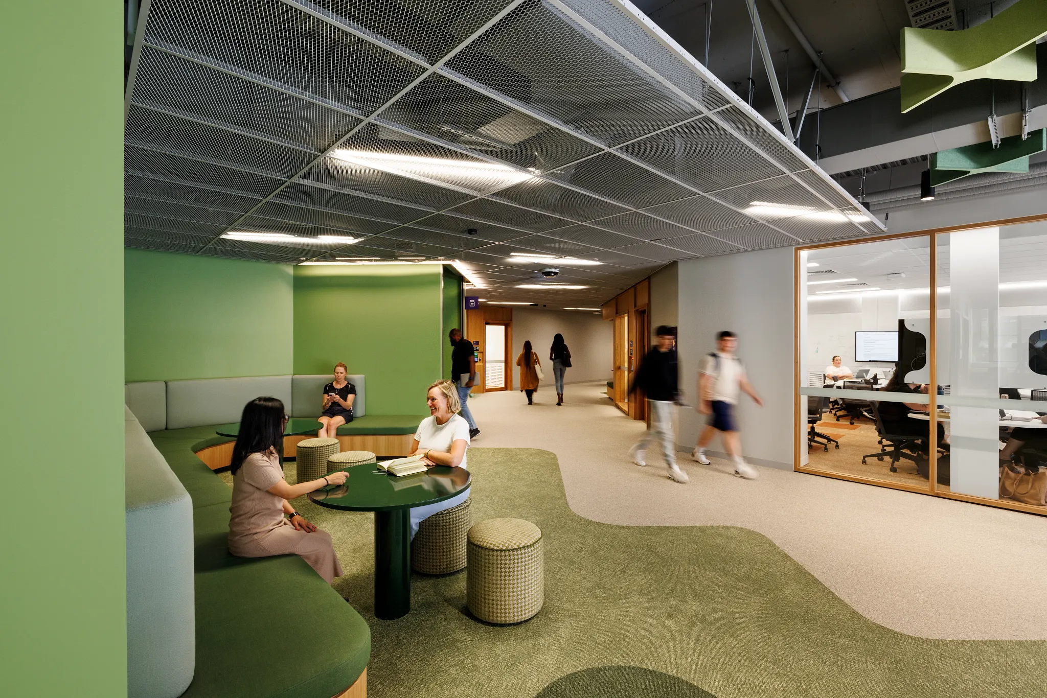 Open learning and collaboration area at Victoria University featuring integrated timber seating, green acoustic ceiling panels, flexible study zones and Shaw Contract flooring.
