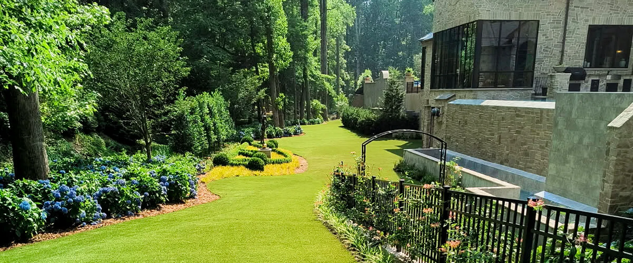 Lush garden landscape with vibrant greenery and stone building