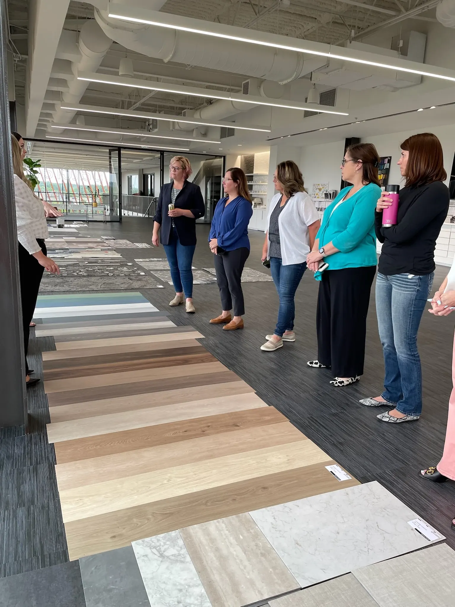 A group of former healthcare nurses looking at different flooring types in the Shaw Contract showroom in Cartersville, Georgia