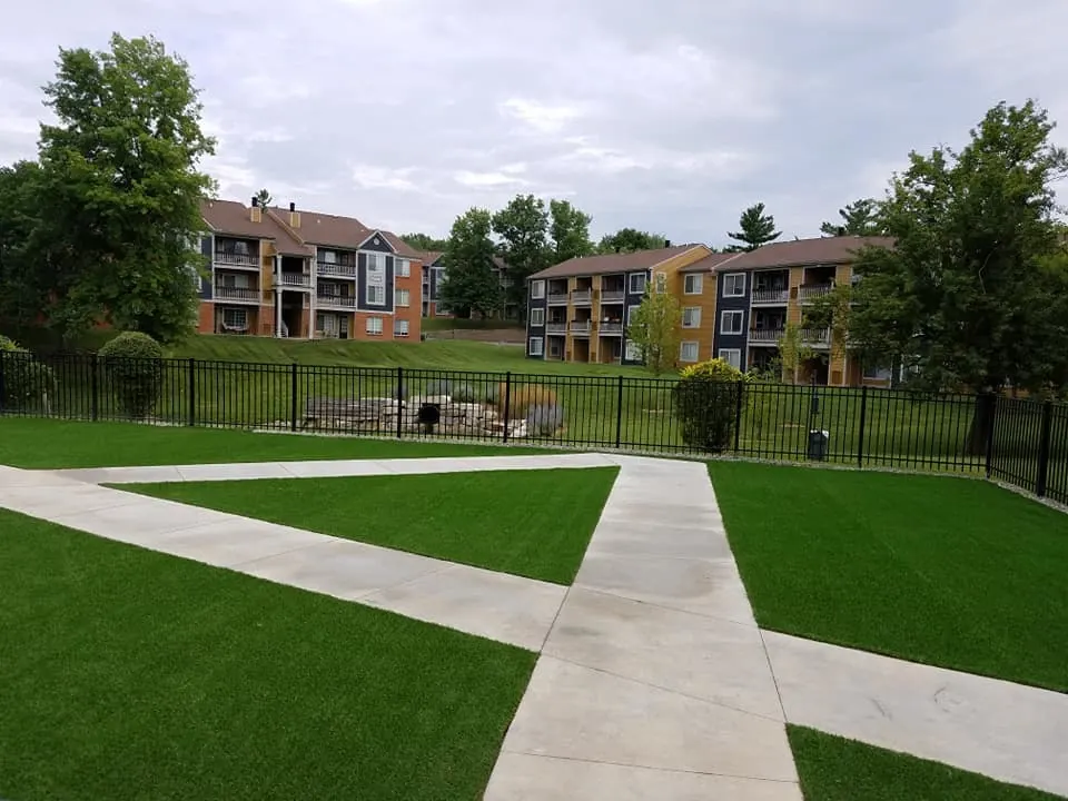Outdoor view of apartment complex with green lawns and pathways