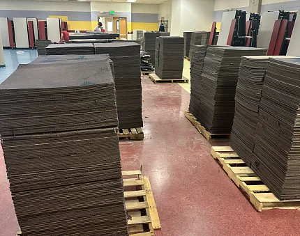 Durable carpet tiles for educational environments Stacks of commercial carpet tiles in an education facility