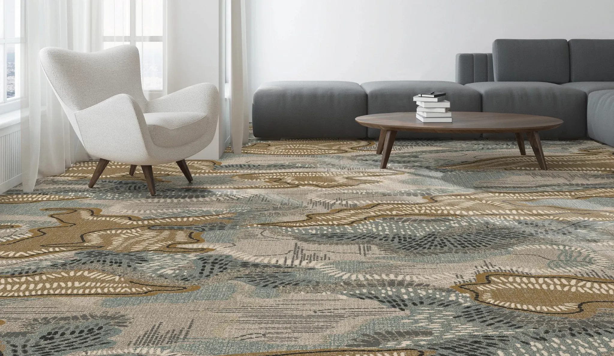 Modern living room with abstract patterned commercial carpet tile in shades of beige, blue, and brown, featuring a white armchair and a gray sectional