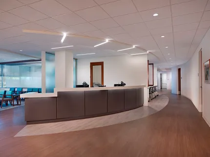 Healthcare Facility with Heavy Commercial Luxury Vinyl Tile Flooring - 47.72x7.28 inch Healthcare facility with heavy commercial luxury vinyl tile flooring featuring a curved reception desk and seating area