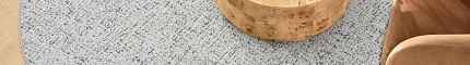Stylish beige area rug for contemporary spaces Beige area rug in a modern living room with wooden flooring