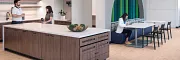 Stylish office kitchen design with elegant wood flooring Modern workplace kitchen with light wood flooring and contemporary furniture