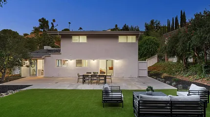 Contemporary outdoor living space with stylish seating Modern backyard with patio furniture and lush greenery