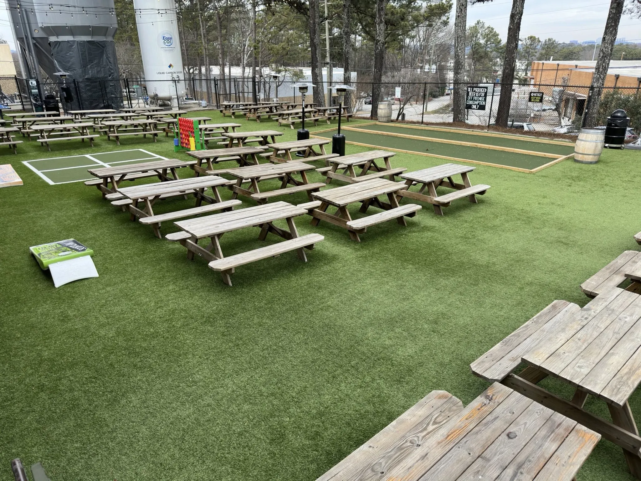 Outdoor area with artificial grass and picnic tables