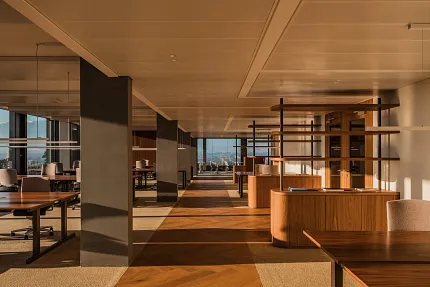 Open office floor plan with view outside and rich wood herringbone floor from Coretec