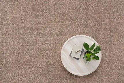 Elegant broadloom carpet in 12 ft width for stylish interiors Broadloom carpet in earthy tones with round table and plant
