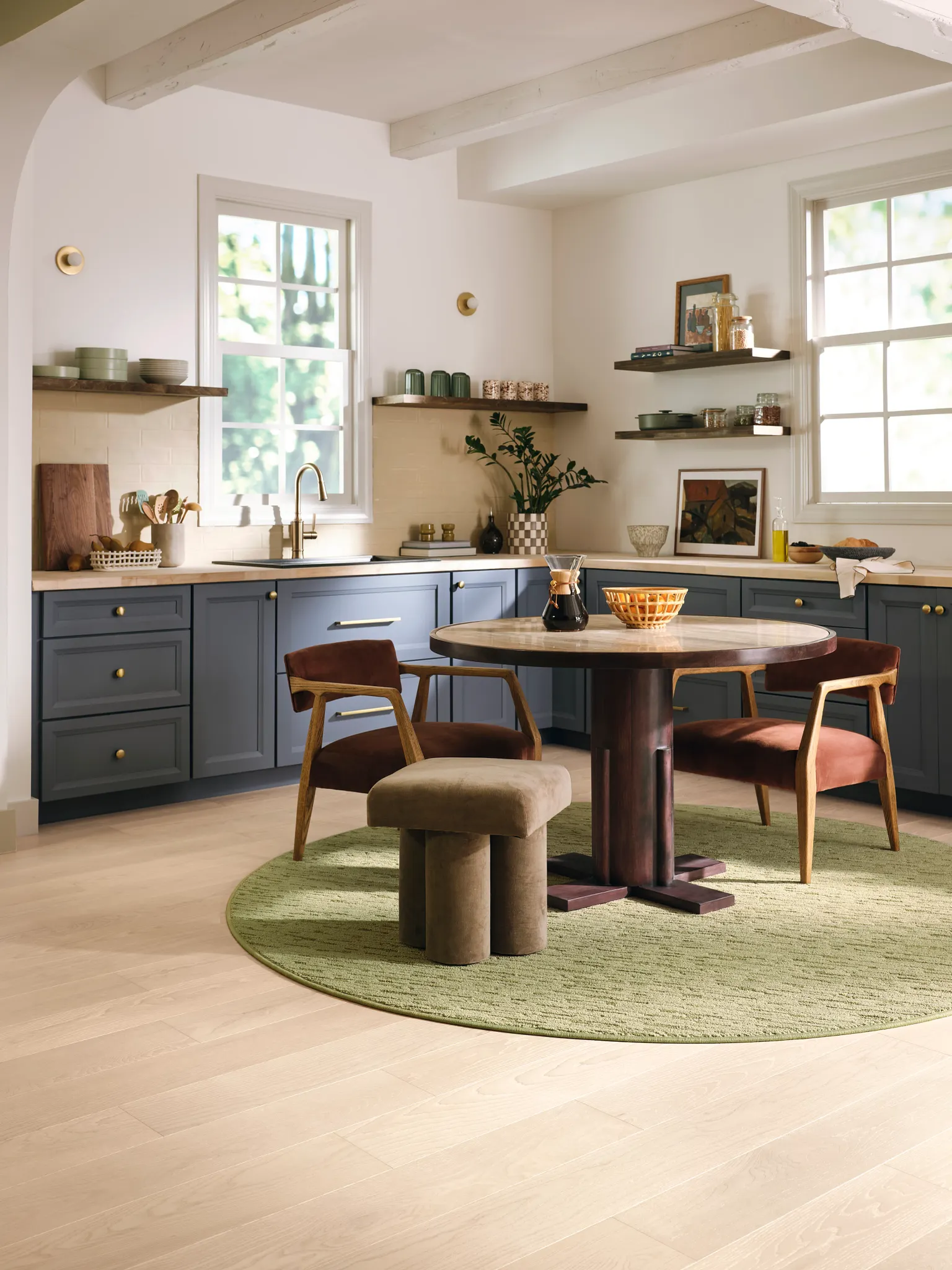 Modern kitchen with round green synthetic carpet and wooden furniture