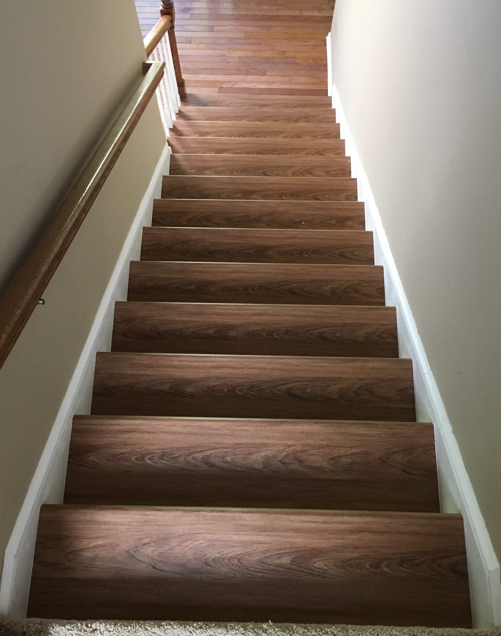 A view from the top of the stairs showing matching stairs with the floor on the bottom floor.