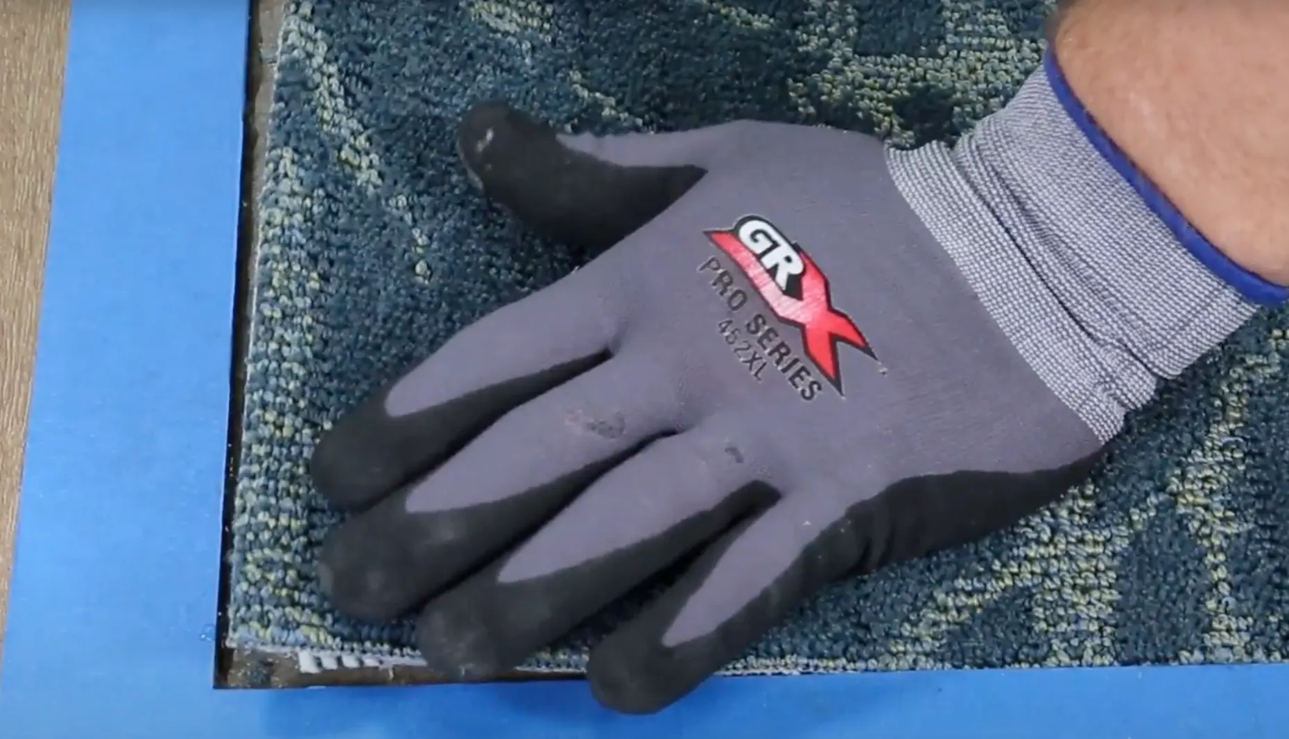 Installation of blue commercial carpet tile with GRX Pro Series glove