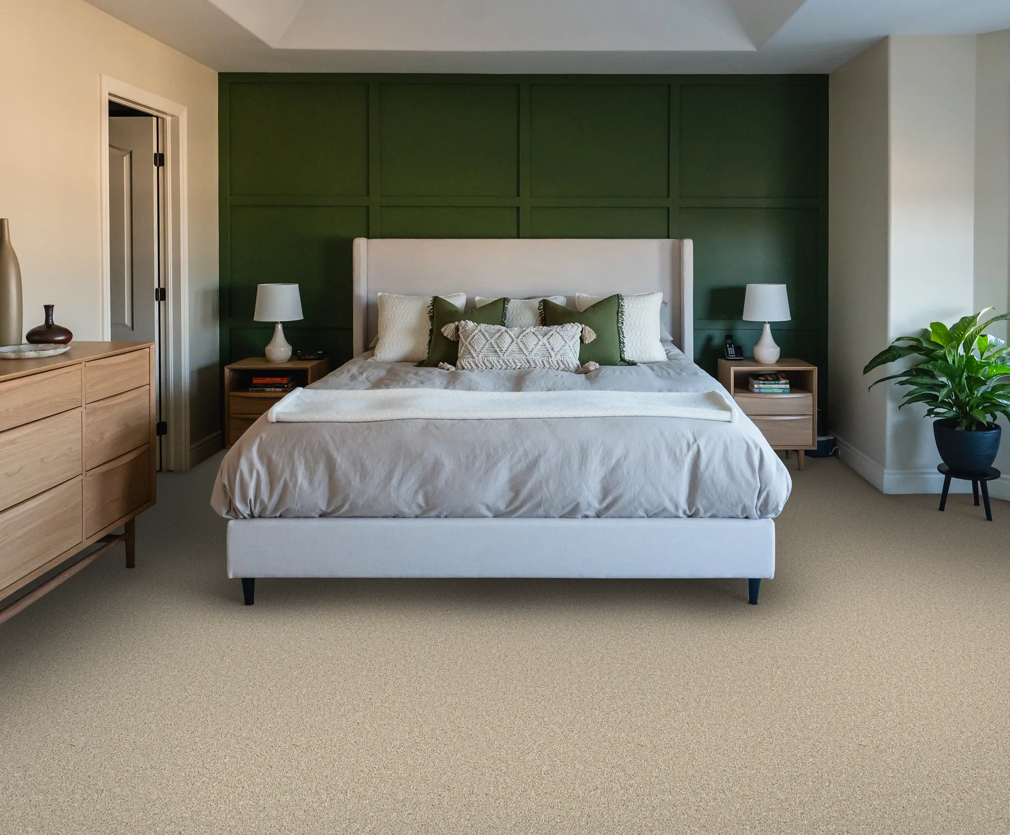Woman kneeling on patterned carpet with a golden retriever in a cozy home setting