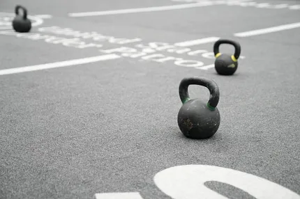 Gym floor with artificial turf and kettlebells Artificial turf with kettlebells on a marked gym floor