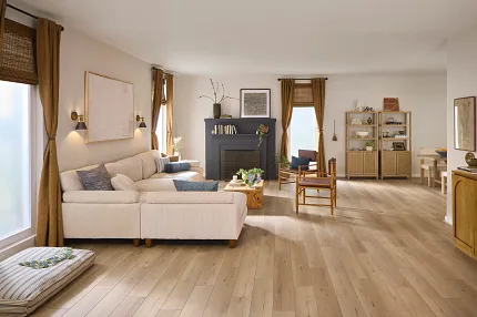 Wood Look Luxury Vinyl Tile Flooring in Modern Kitchern Scene Man cleaning luxury vinyl plank flooring in a stylish, modern home. The kitchen features wooden cabinets, black appliances and an open door leading to a staircase