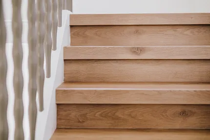 Close up wooden staircase renovation with Coretec floors