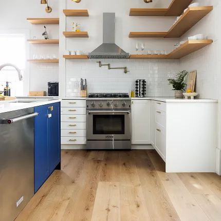 Coretec Residential SPC Luxury Vinyl Plank Flooring in Modern Kitchen - 72.83x9.06 inch kitchen with luxury vinyl plank floor in a wood look with blue cabinets and stainless steel appliances