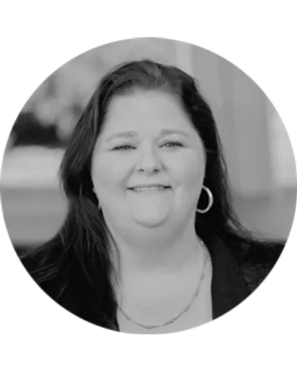 Professional portrait of a woman in grayscale with jewelry accessories Black and white image of a woman with long dark hair wearing hoop earrings and a necklace