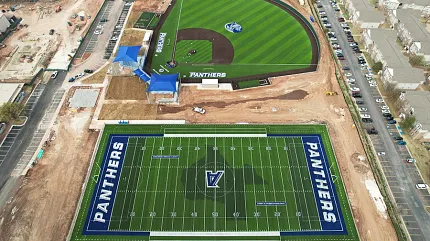 Artificial Turf Sports Complex with Panthers Branding Aerial view of sports complex featuring artificial turf fields for football and baseball with "Panthers" branding