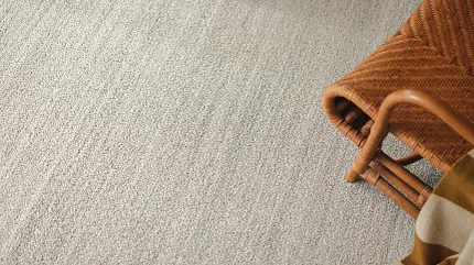 Cozy beige carpet for stylish interiors Beige carpet flooring with woven chair and blanket