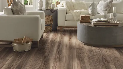 Elegant Hardwood Flooring in a Cozy Living Room Setting Cozy living room with elegant hardwood flooring, featuring a warm brown tone, complemented by modern white and gray furniture