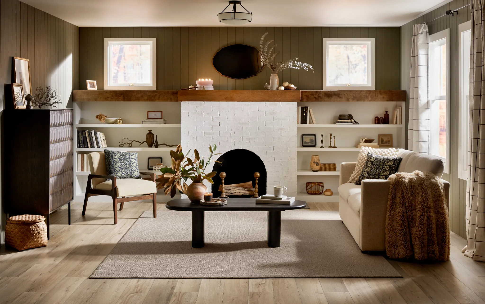 Cozy living room with SPC flooring in natural wood tones, featuring a white brick fireplace, beige sofa, and modern decor