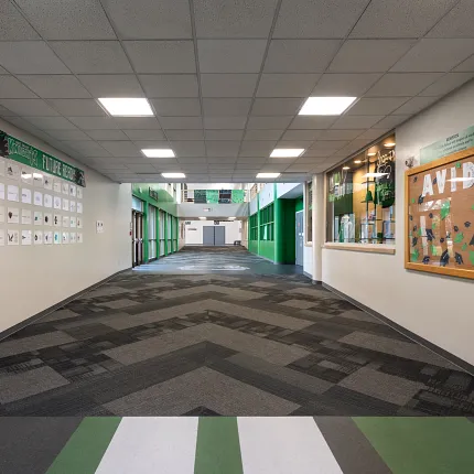 Durable LVT flooring in educational spaces Heavy commercial luxury vinyl tile in an education facility hallway