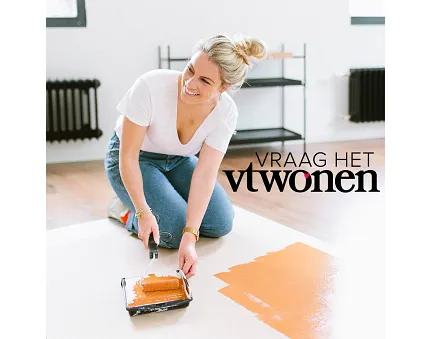 Modern room floor painting with orange color Woman painting a floor with orange paint in a modern room setting