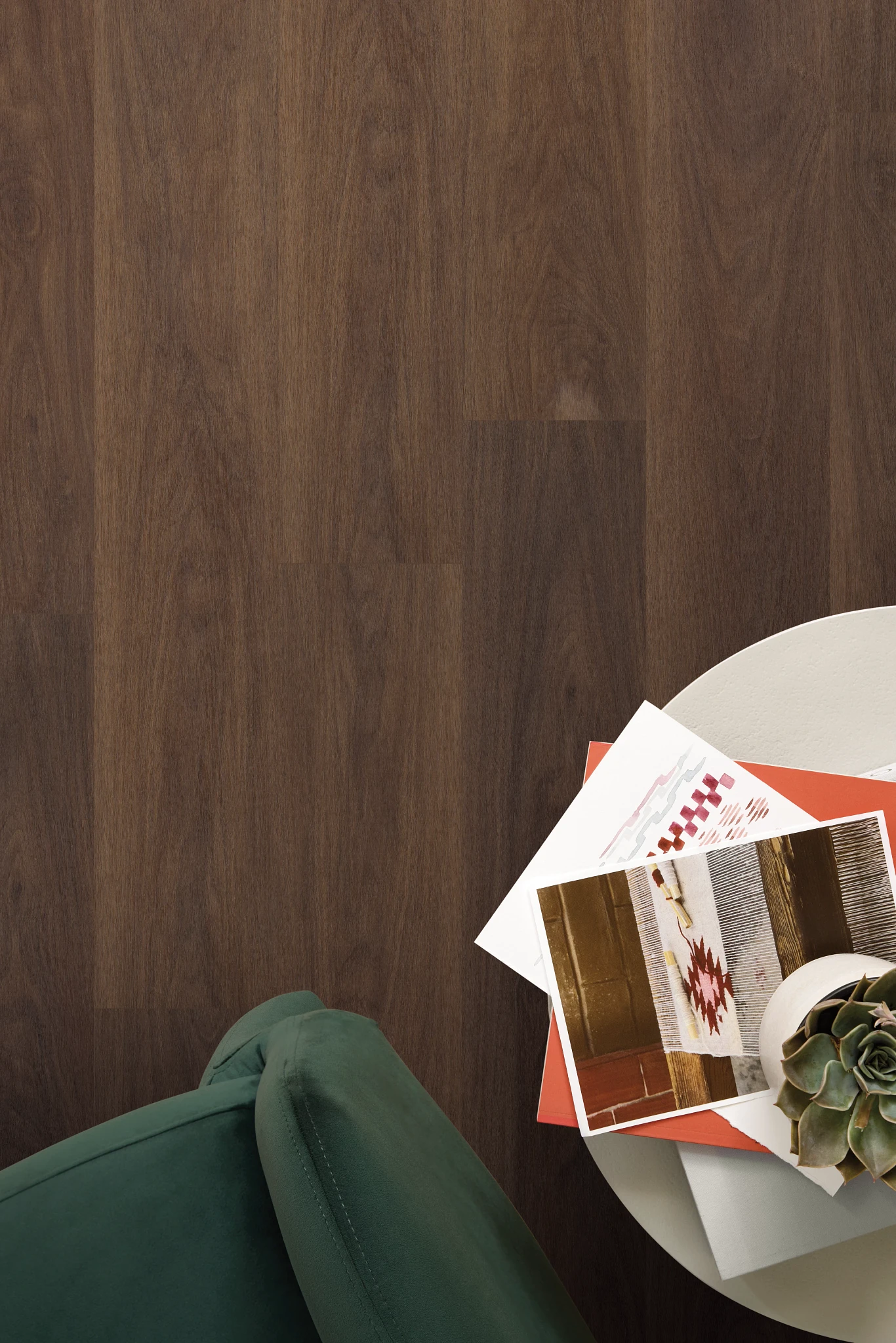 Top-down view of dark wood look luxury vinyl tile flooring from the Serene collection with a round side table, magazines, a succulent plant and upholstered seating.