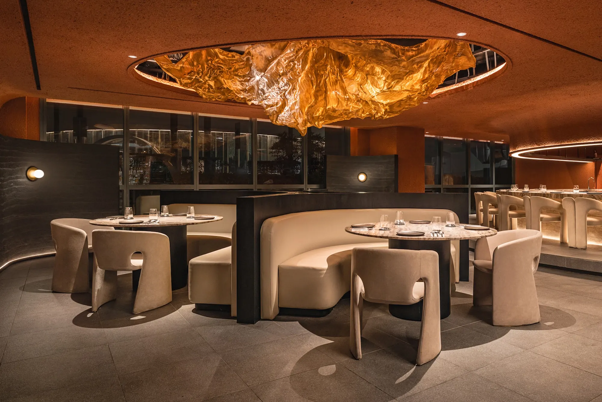 Modern restaurant interior with elegant seating and warm lighting, featuring commercial ceramic tile flooring